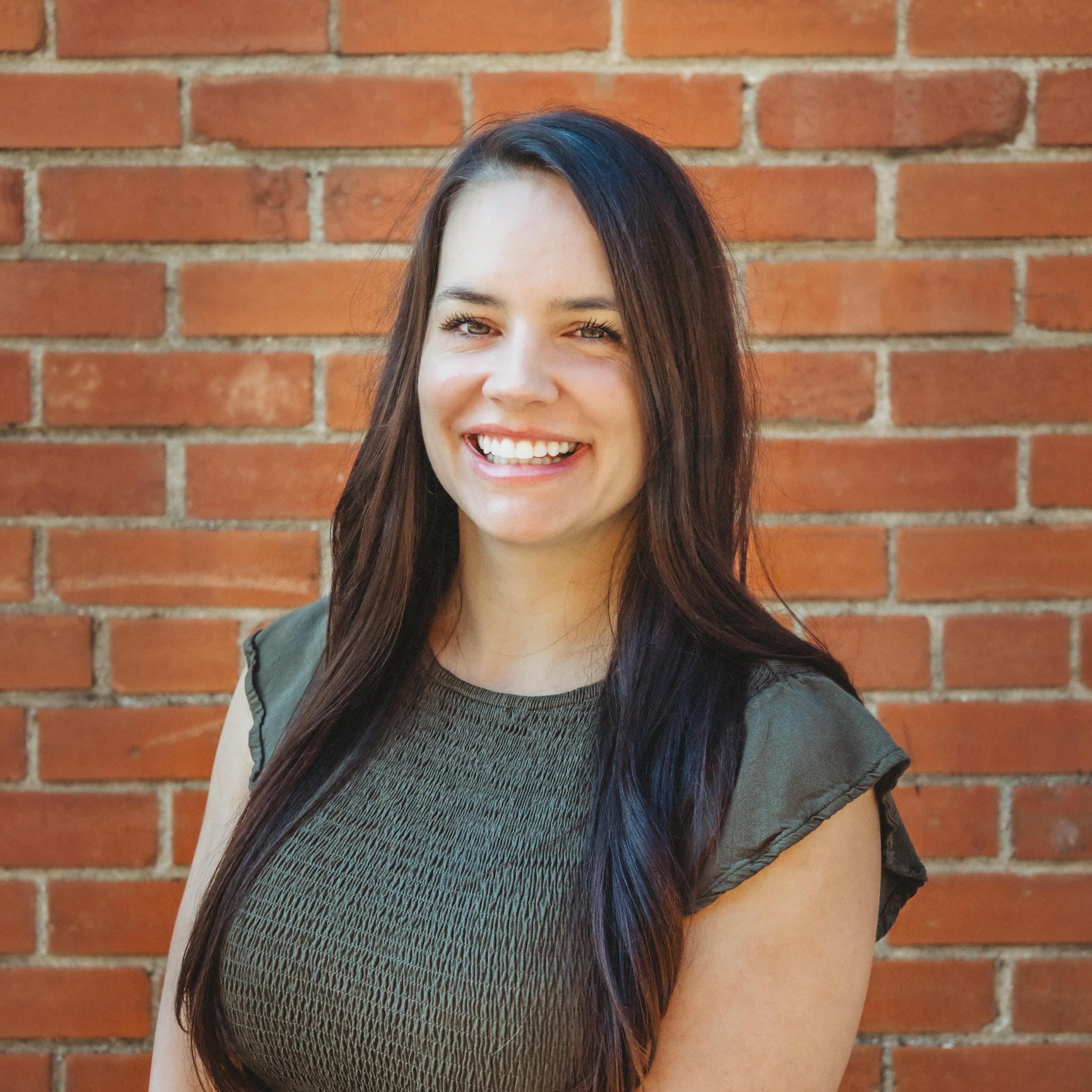Headshot of Terry Fabrizio standing in front of a brick wall