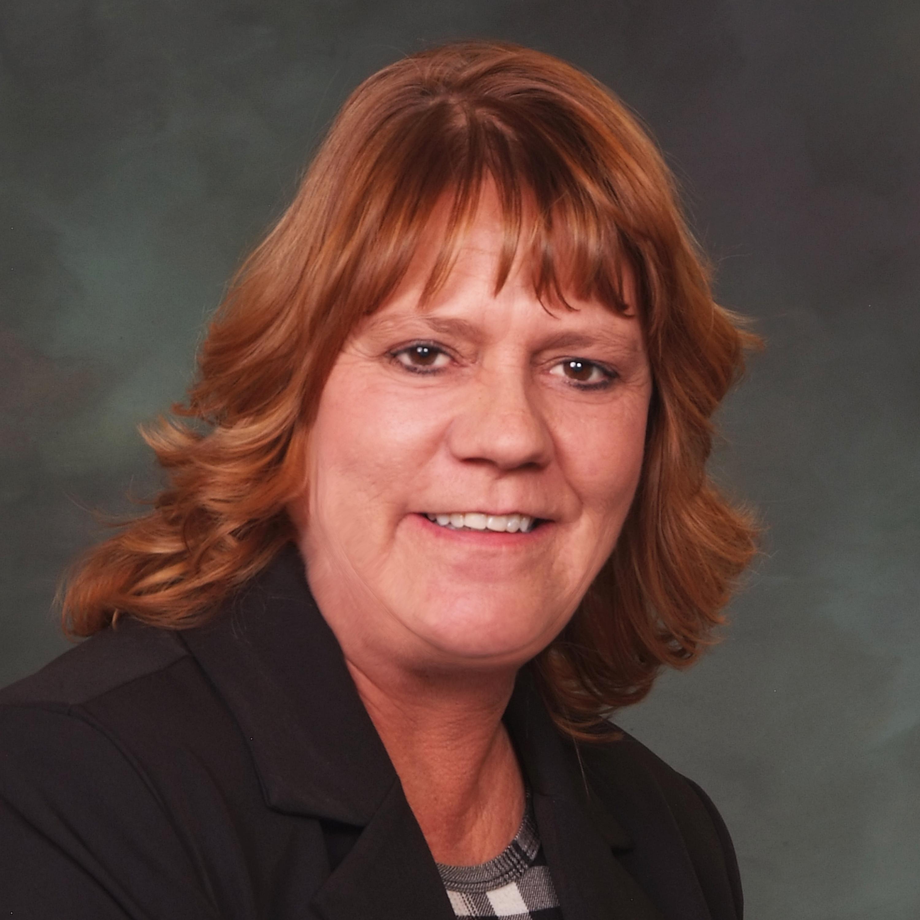 Headshot of Representative Tisha Mauro, smiling, wearing a black jacket