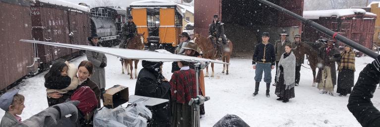 busy film set in winter next to trains