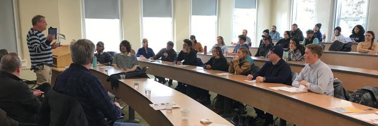 presenters in classroom full of students