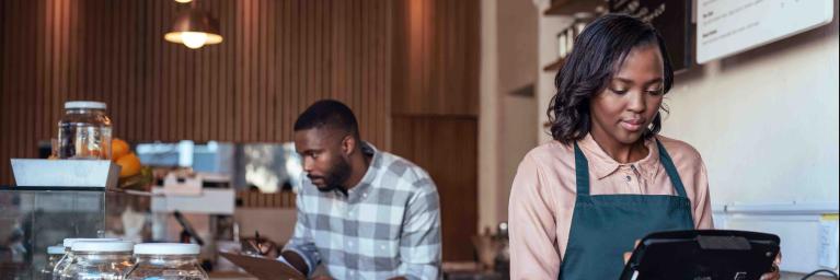 two business owners standing near cash register