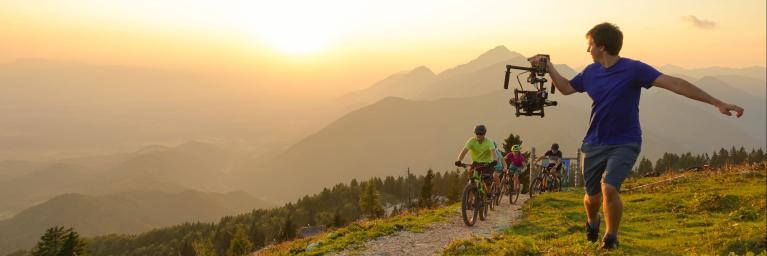 filmmaker capturing mountain bikers