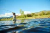 An angler casts their fishing rod into a river