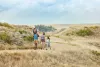 A family of four hikes a path in Yuma County on a sunny day.