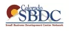 Image of Colorado SBDC in Blue font. There is a gray line of mountains behind it and a blue line holding the Colorado SBDC words. Beneath is in red font Small Business Development Center Network words. There is also a Red C with an internal yellow dot next to the gray mountain outline